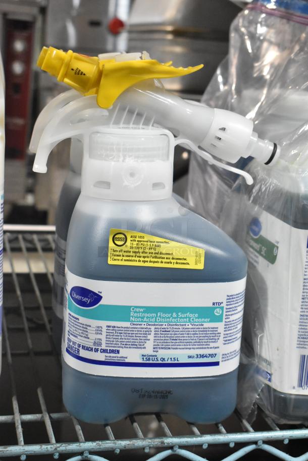 Two-tier lot of cleaners including Diversey Wiwax Maintenance Emulsion, Diversey Restroom Floor Cleaner, and Scott Foam Skin Cleanser.