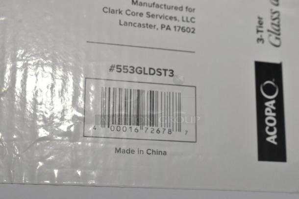 2 boxes of Acopa 553GLDST3 3-tier glass/stainless steel display stands, scratch/dent, tag shows barcode and "Made in China".