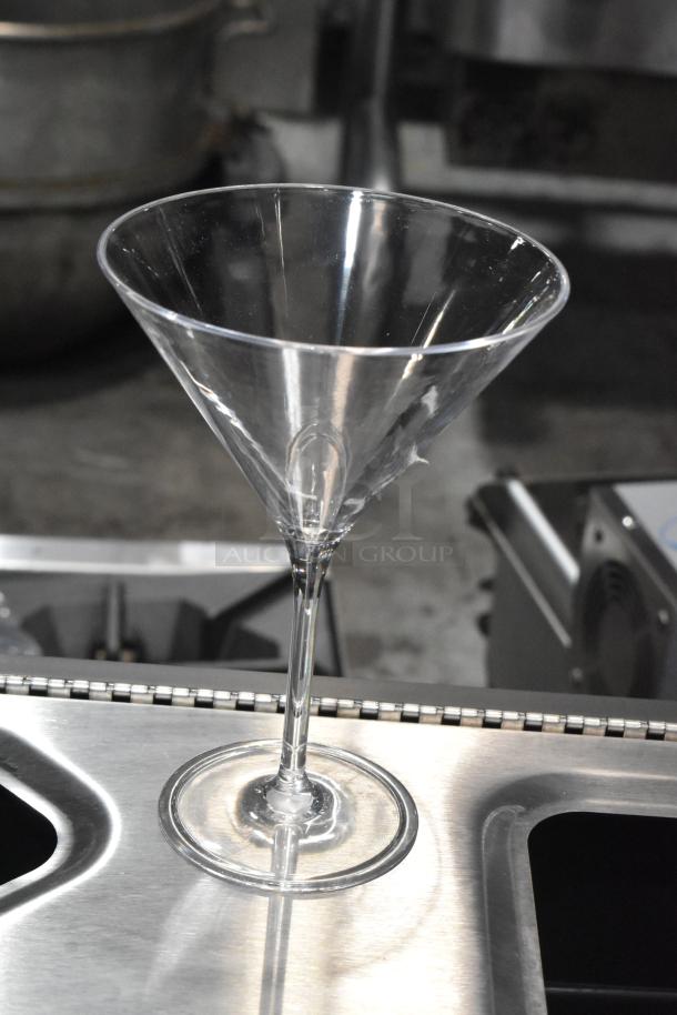 Carlisle 564607 Alibi 9 oz. plastic martini glass standing on a metal surface; brand new, scratch, and dent condition.