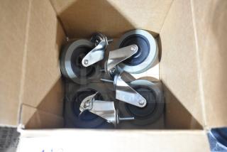 Lot of 4 commercial casters, brand new with minor scratches. Includes screws for mounting, steel frames, rubber wheels in a box.
