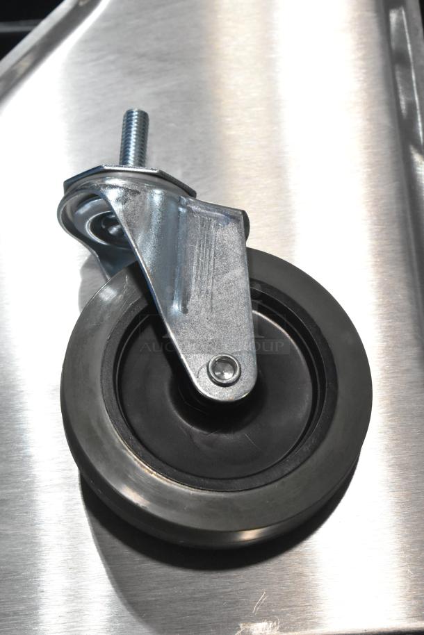 Lot of 4 brand new commercial casters with minor scratches and dents, featuring sturdy metal frames and rubber wheels.