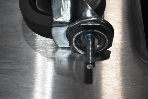 Lot of 4 commercial casters, brand new with minor scratches. Heavy-duty metal construction, threaded stem visible.