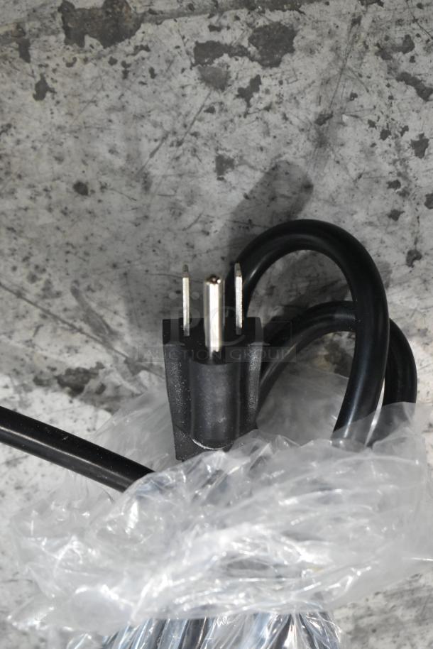 Black power plug of Avantco 177C10 Coffee Maker wrapped in clear plastic packaging.