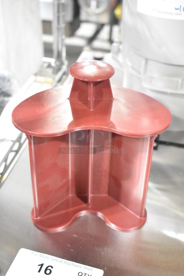 Lot of Robot Coupe food processor accessories including a burgundy plastic pusher, brand new condition, some scratches visible.