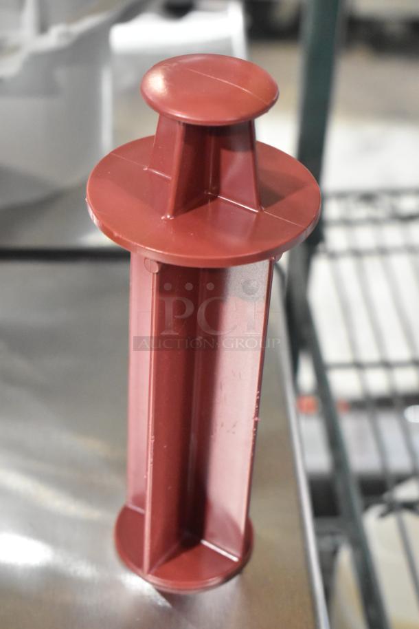 Brown pusher accessory for Robot Coupe food processor, new condition. Part of a lot including bowl, feed head, S blade.