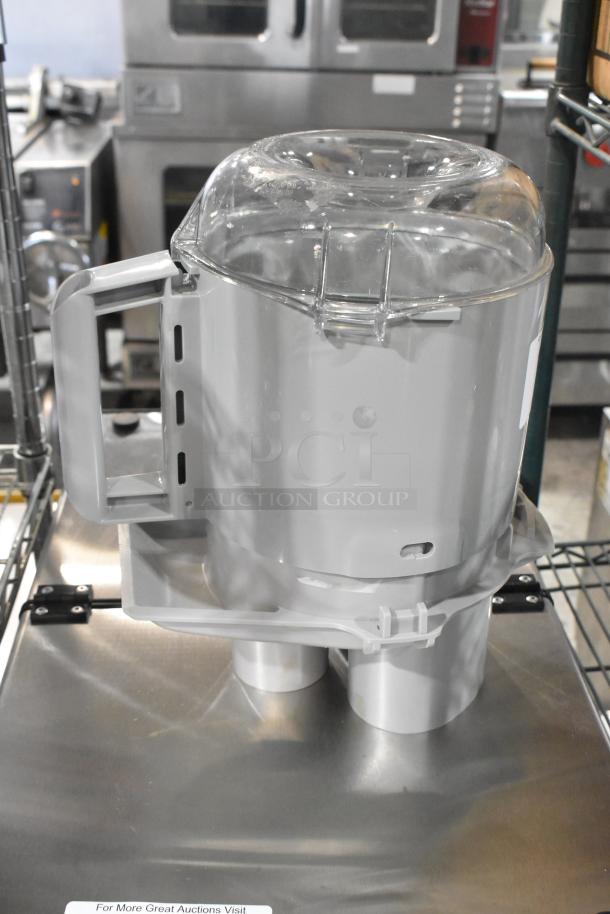Brand new Robot Coupe food processor accessories, including a bowl, continuous feed head, S blade, and pusher.