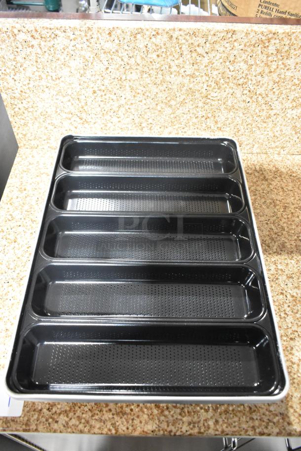 Set of 5 non-stick metal bread pans, scratch and dent condition, featuring perforated slots for even baking. Brand new.