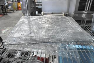 Five new 17.5" x 17.5" Assure 190FS175175 mesh fryer screens, Pitco P6072186 equivalent, in packaging on a rack.
