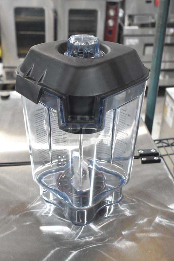 Brand new blender pitcher with clear measurements, black lid, and transparent design. Part of a scratch and dent set.
