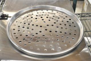 Brand new perforated metal baking pan, round, scratch and dent condition. Auction lot of 40 pans.