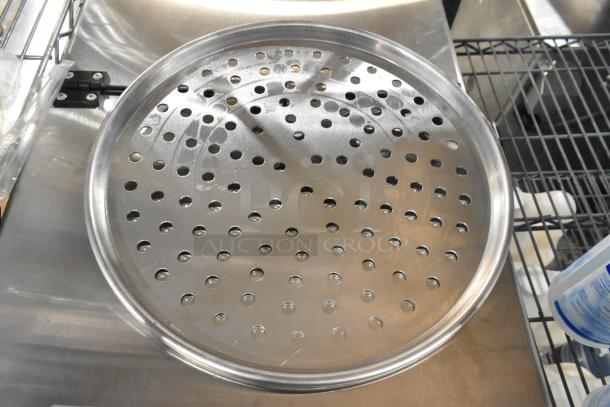 Brand new metal round perforated baking pan with minor scratches. Set of 40, auction includes all. Ideal for baking.