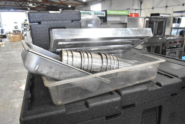 Lot of metal grease hood filters, metal mixing cups, and drop-in bins in used condition.