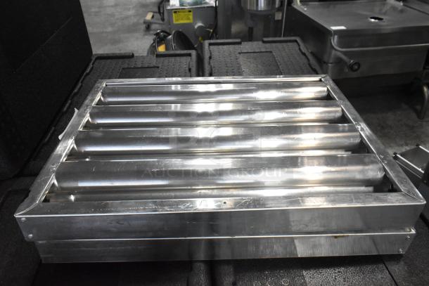 Lot of metal items including a grease hood filter, mixing cups, and drop-in bins, in used condition. Shiny and reflective surfaces.