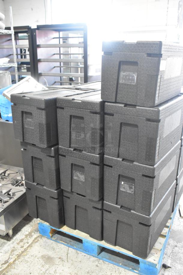 19 black polyfoam insulated portable coolers stacked on a pallet, new condition, ideal for temperature-sensitive transport.