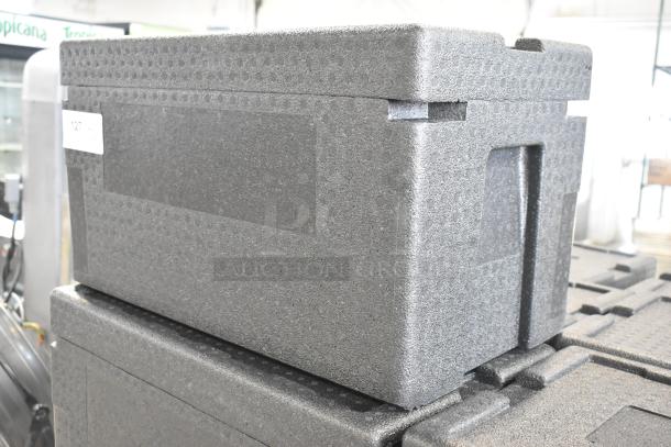 Black polyfoam portable cooler, insulated, stackable design, slightly used. Includes auction label with lot number.