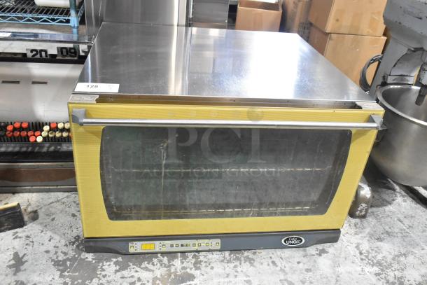 Cadco Unox XAF195 stainless steel commercial convection oven, countertop electric model, visible wear, digital controls.
