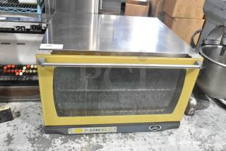 Cadco Unox XAF195 stainless steel commercial convection oven, countertop electric model, visible wear, digital controls.