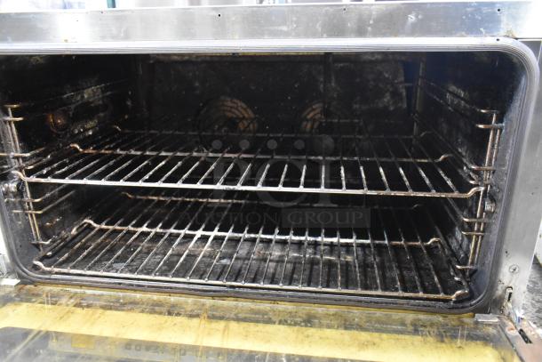 Cadco Unox XAF195 stainless steel convection oven, electric-powered, dual racks, used condition, suitable for commercial use.