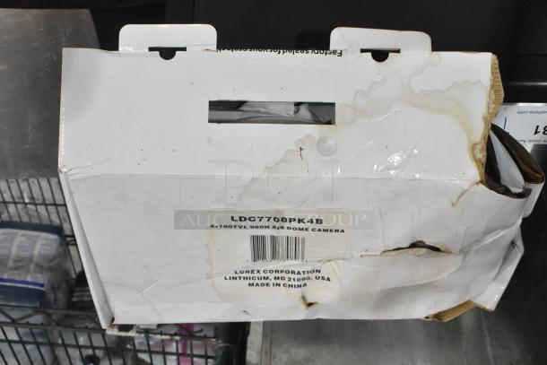 Lorex LDC7708PK4B Dome Camera box with visible wear and tear. Label reads "4x700TVL 960H A/S Dome Camera." Made in China.