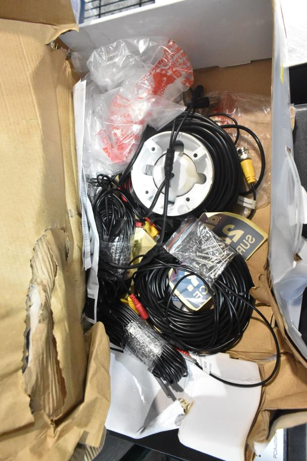 Lorex LDC7708PK4B dome camera in original packaging, includes wiring and accessories. Box shows slight wear.
