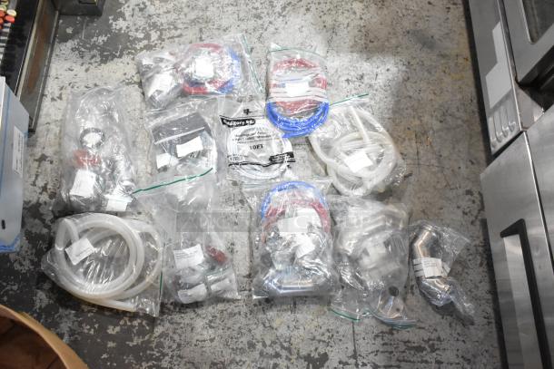 Lot of brand new scratch and dent items, including hoses and stacking kits, sealed in plastic bags, with visible labels.