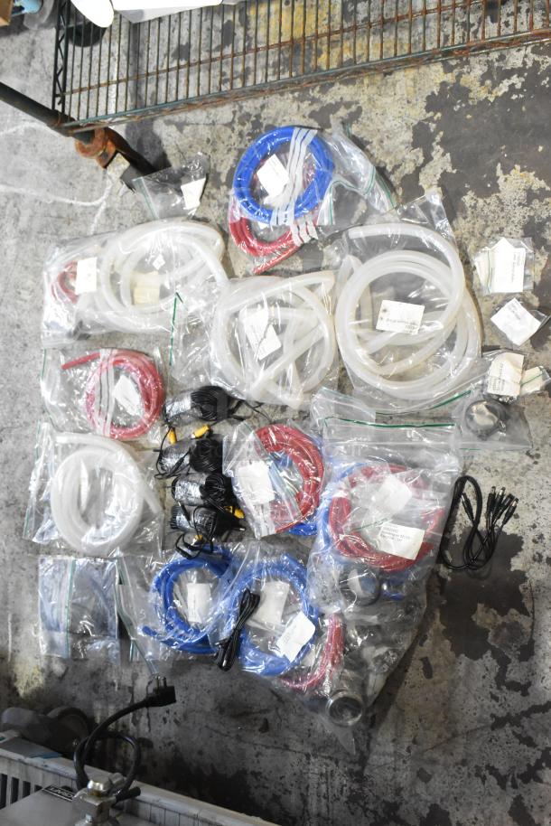 Lot of brand new scratch and dent items including hoses and stacking kits, various colors, in sealed bags with labels.