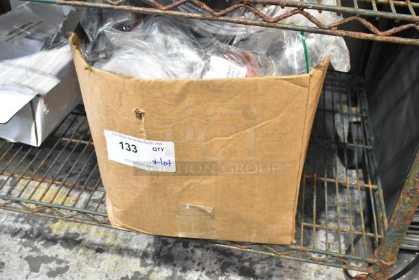 Box labeled "133 QTY" containing brand new scratch and dent items, including hoses and stacking kits.