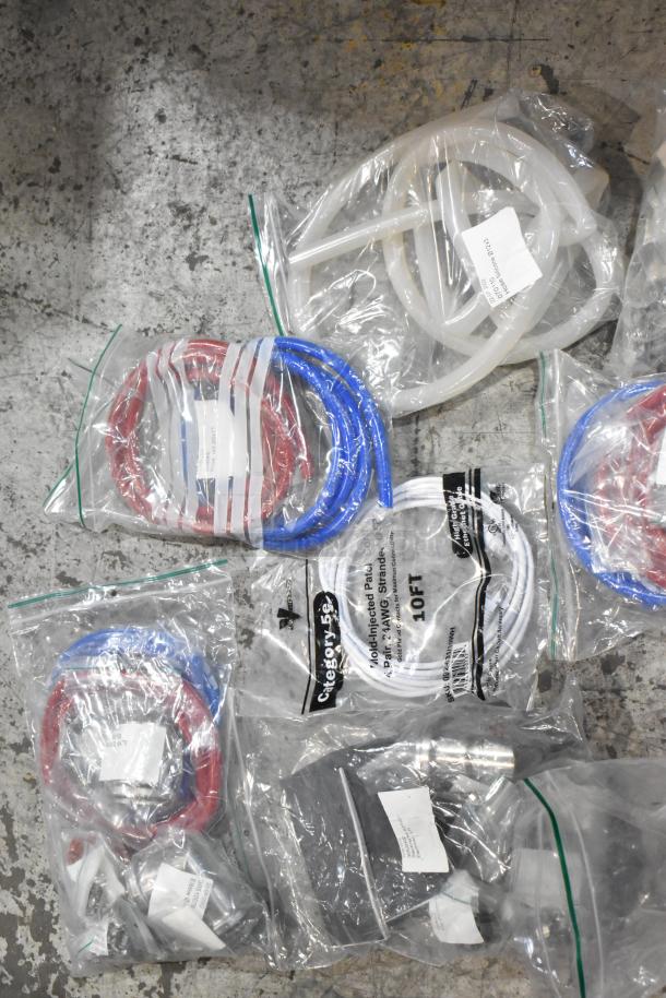 Brand new lot of scratch and dent items, including hoses and stacking kits, in sealed plastic bags.
