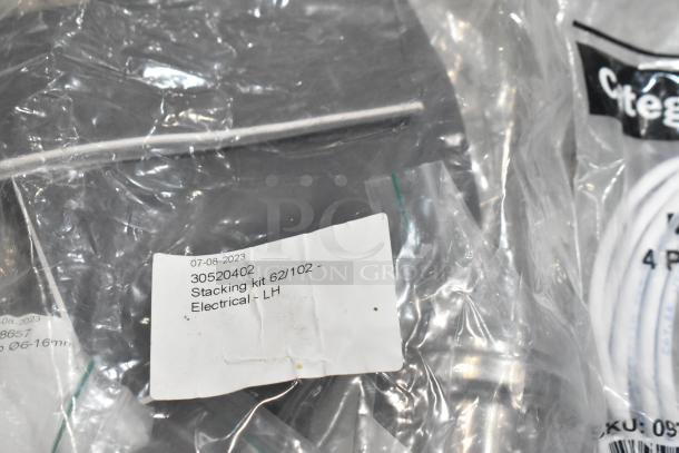 Lot of brand new scratch and dent items, including hoses and stacking kits. Visible label shows date "07-08-2023" and code "30520402".