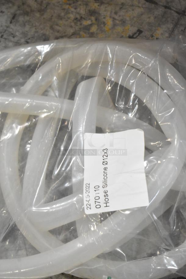 Lot of brand new scratch and dent silicone hoses, labeled "070/110 Hose Silicone Ø12x3," in packaging.