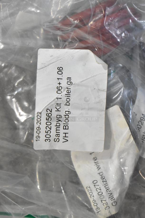 Bag of assorted new items labeled "Sambyg Kit 1.06+1.06" with visible date "19-09-2022." Includes hoses, stacking kits.