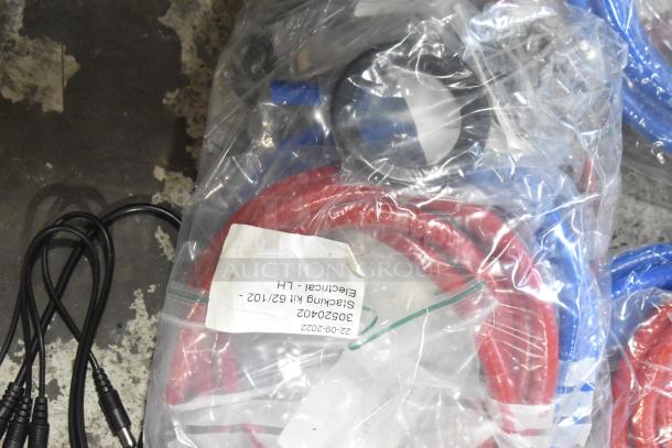 Lot of brand new scratch and dent items, including hoses and stacking kits. Visible tag: "Stacking Kit 62/102, Electrical."