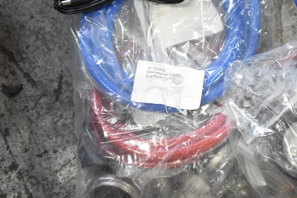 Lot of brand new scratch and dent items, including hoses and stacking kits. Label reads: "Stacking kit 62/102 - Electrical - LH."