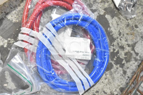 Lot of new hoses, red and blue, in packaging with tags. Includes 065050, "Hose Blue 08X11", dated 19-09-2022.