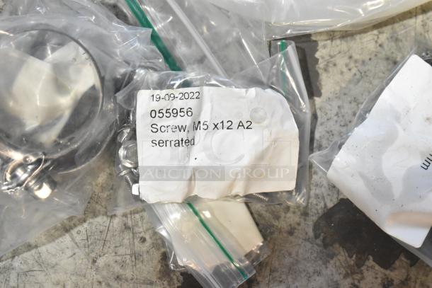 Lot of brand new, scratch and dent items including hoses and stacking kits. Label shows "055956 Screw, M5 x12 A2 serrated".