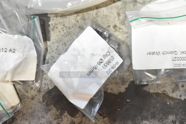 Lot of brand new scratch and dent items, including hoses and stacking kits. Labels indicate various clips and parts.