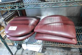 4 maroon seat cushions, brand new with minor scratches, labeled "134 QTY 4X," shelf-stored, durable and comfortable.