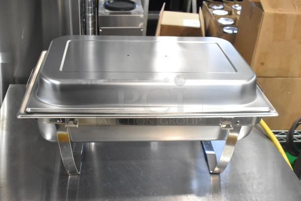 Brand new stainless steel chafer with scratch and dent, featuring a drop-in bin and lid, in excellent condition.