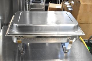 Brand new stainless steel chafer with scratch and dent, featuring a drop-in bin and lid, in excellent condition.