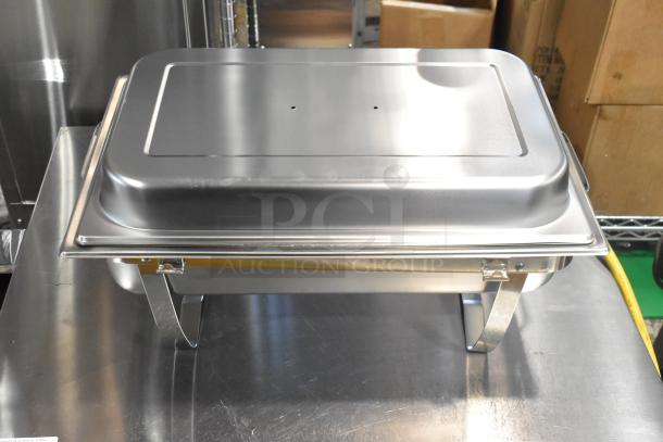 Brand new stainless steel chafer with drop-in bin and lid, minor scratches, sturdy legs, perfect for catering use.