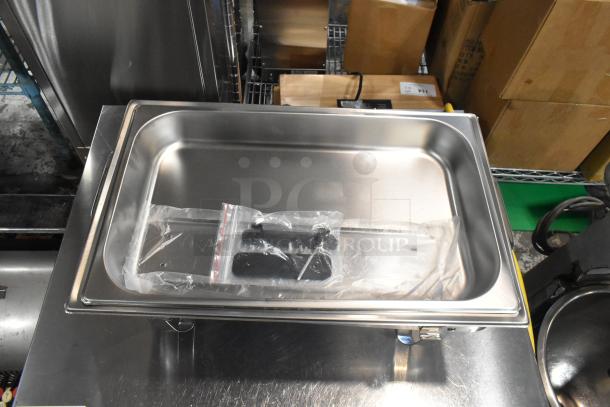 Stainless steel chafer with drop-in bin and lid, brand new with minor scratches, includes hardware in sealed bag.