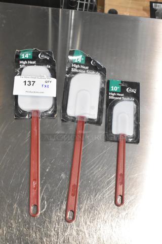 Three brand new high-heat silicone spatulas, sizes 14" and 10", in original packaging. Includes models 40714HSPNULA, 40714HSPTULA, 40710HSPTULA.
