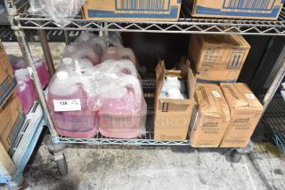 Tier lot of various cleaning items on a shelf, including Diversey Pan Clean Detergent, Scott Skin Cleanser, and Purell Hand Sanitizer.