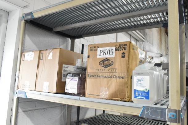 Tier lot of cleaning items on a shelf, including Gojo foam handwash, Scott foam skin cleanser, and Clorox bleach cleaner.