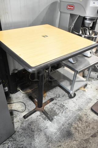 Bar height table with wood pattern top and black metal base. Square design, sturdy condition.