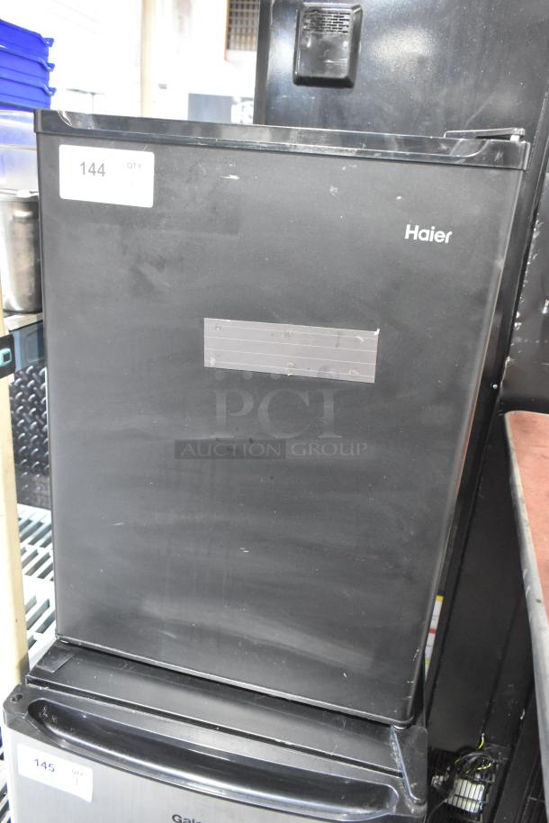 Haier HC27SF10RB Mini Cooler, black, 115 volts, 1 phase, good condition, with label indicating model and capacity.