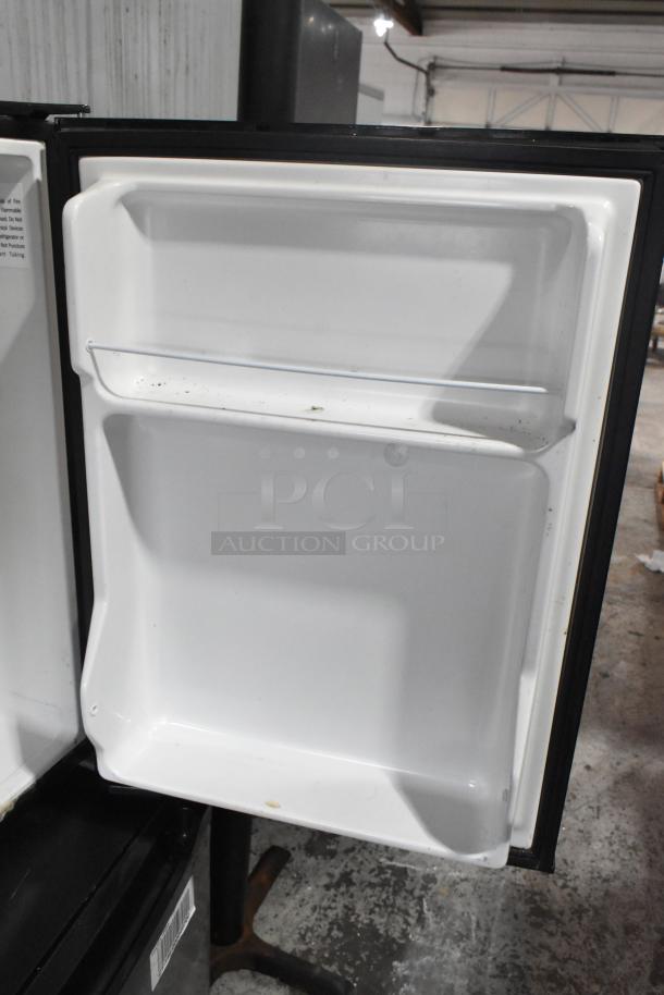 Haier HC27SF10RB mini cooler, open door showing shelves. Good condition. 115 Volts, 1 Phase, label visible inside.