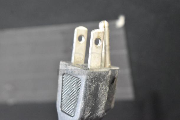 Two-prong electrical plug for Haier HC27SF10RB Mini Cooler, 115 volts, 1 phase, showing wear, detail of attachment point.