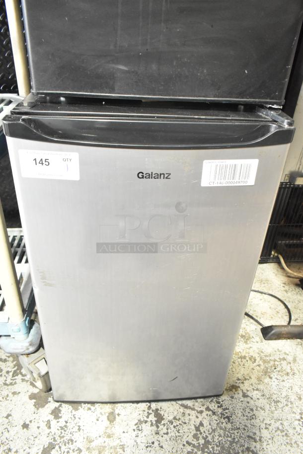 Galanz GL43S5 Mini Cooler, 115V, stainless steel finish. Visible labels: "145, QTY 1". Some surface wear.