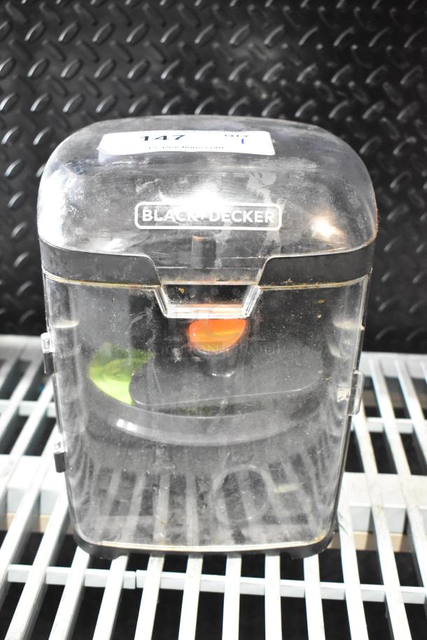 Black & Decker food processor accessories in hard case, visible blades inside, case shows signs of wear.